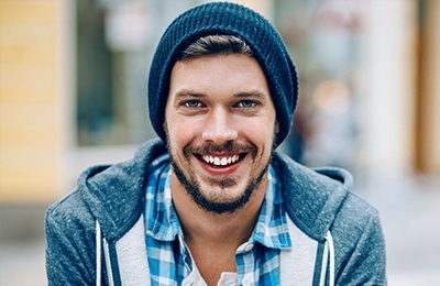 man with beanie smiling