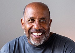 Closeup of senior man in gray shirt smiling