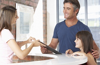 father and daughter at front desk