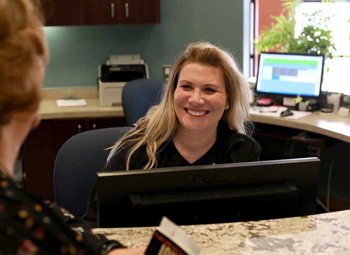 front desk worker smiling