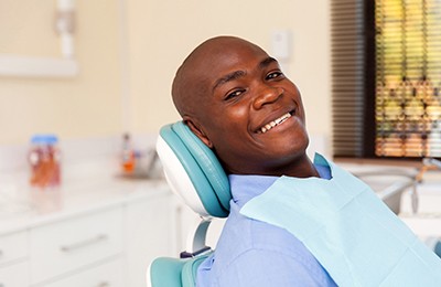  Man smiles after getting dental bridge in Brownstown 