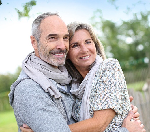 husband and wife smiling