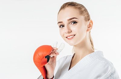 woman putting mouthguard in