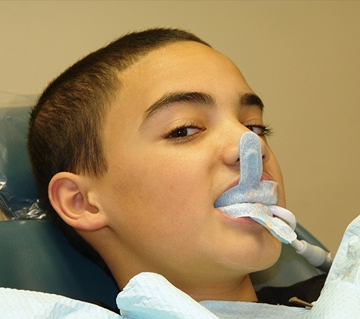 boy with tooth molds in