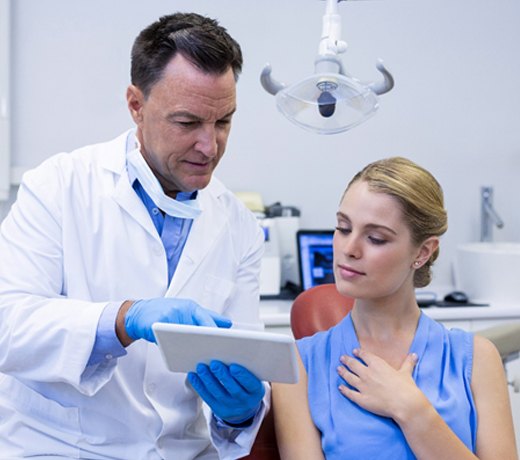 A female patient discussing with her dentist