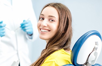 woman in yellow smiling