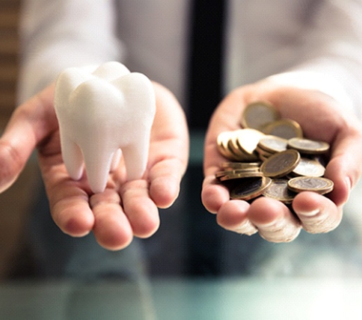 Someone holding a tooth and handful of coins