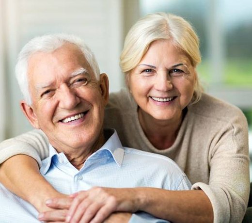 An older couple with dental implants in Brownstown smiling