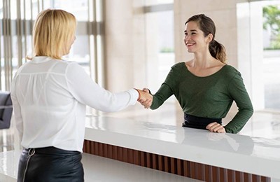 Employee shaking hands with a patient