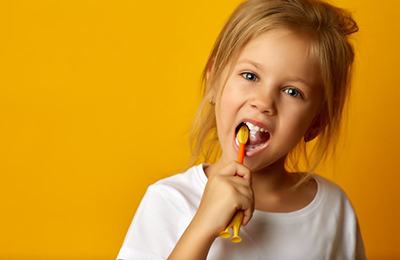 little girl brushing her teeth