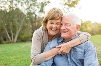 older couple hugging smiling