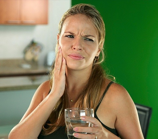 woman in green room with jaw pain