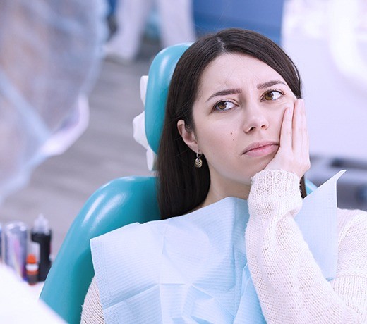 woman in pink sweater in pain