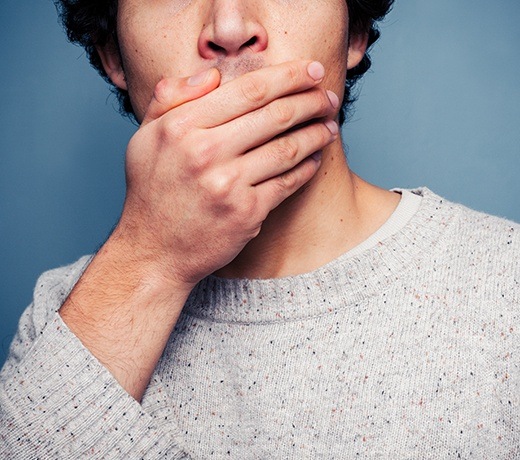 man covering mouth