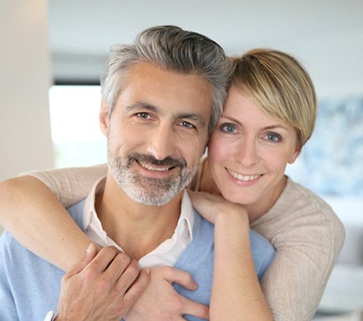 Happy couple with dental implants