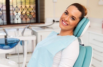 woman laying back in light blue chair