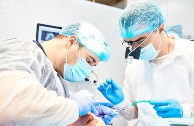 dental surgeons placing dental implant