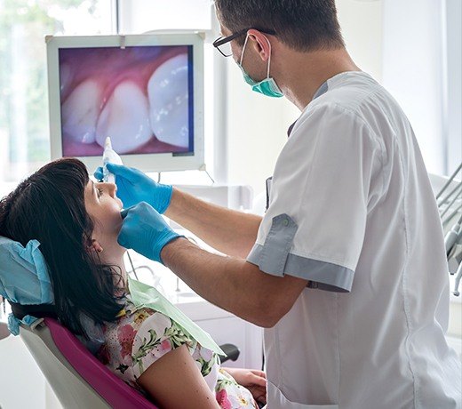 dentist using intraoral camera