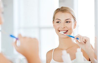 woman brushing teeth