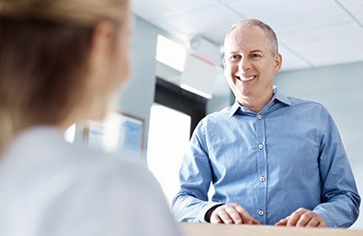 man at from desk smiling