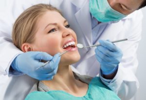 a woman having her teeth checked at the dentist’s office