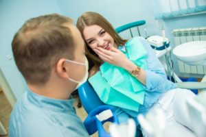 young woman smiling with her dentist before getting fillings 