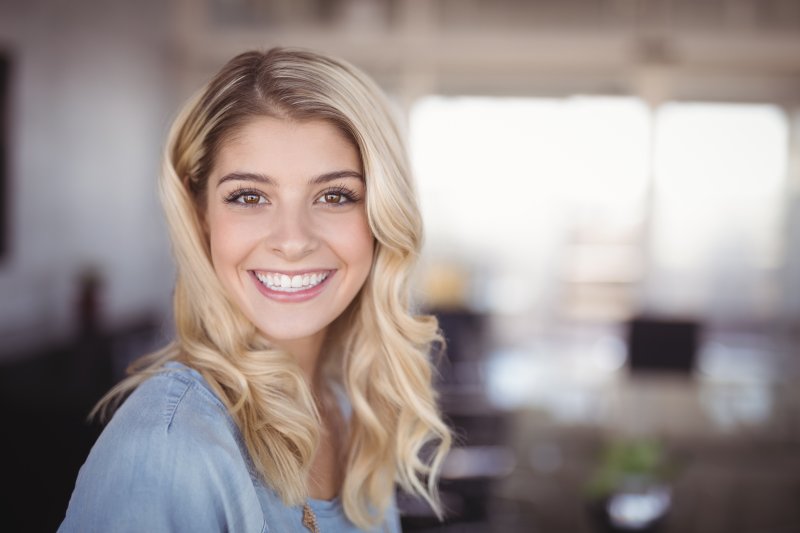 person with dental fillings smiling