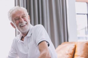 a happy man smiling with dentures